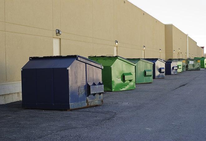 a row of industrial dumpsters for construction waste in Carney